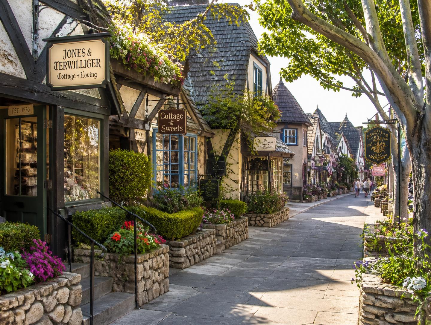 Carmel-by-the-Sea village street lined with cottage storefronts and flowers